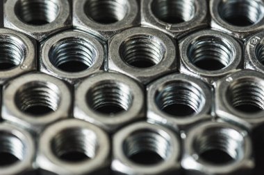 Karanlık arka planda izole edilmiş metal fındıklar. Krom vida fındık izole. Çelik ceviz izole. İş için araçlar.