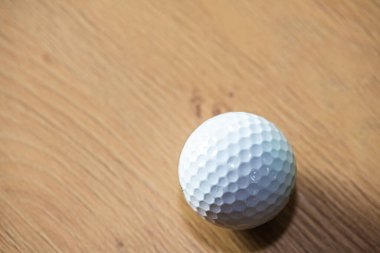 Tahta yüzeyde beyaz golf topu