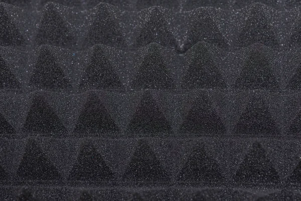 Sound proof Acoustic black gray foam absorbing, pyramid style padding layer panel for voice recording studio attach on wall as wallpaper background to reduce and protect sound to outside room.