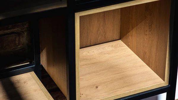 stock image Fragment of light wooden cabinet. Empty cabinet shelves. Wooden shelf in a metal frame with empty racks 