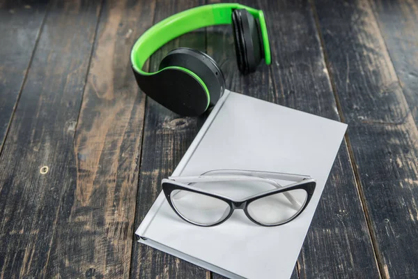 Wooden Surface Headphones Green White Notebook Glasses — Stock Photo, Image