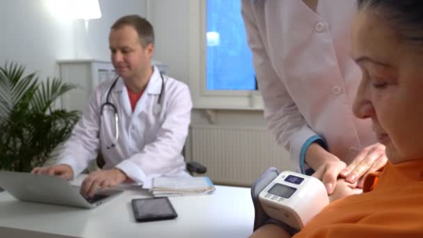 Doctors use digital Medical tonometer for measuring blood pressure — Stock Video