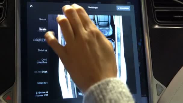 The Interior Of A Tesla Model X Electric Car With Large Touch Screen Dashboard