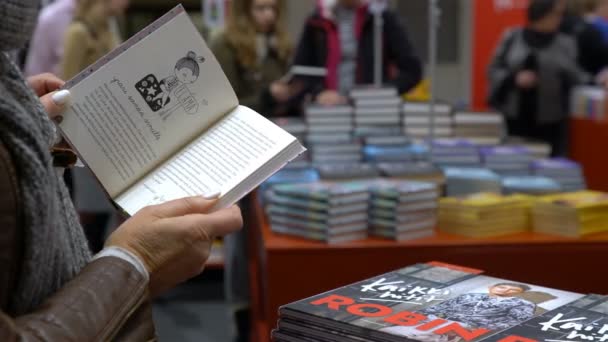 Vele liefhebbers van lezen, kopers, uitgevers en boeken op de grote boekenbeurs. — Stockvideo