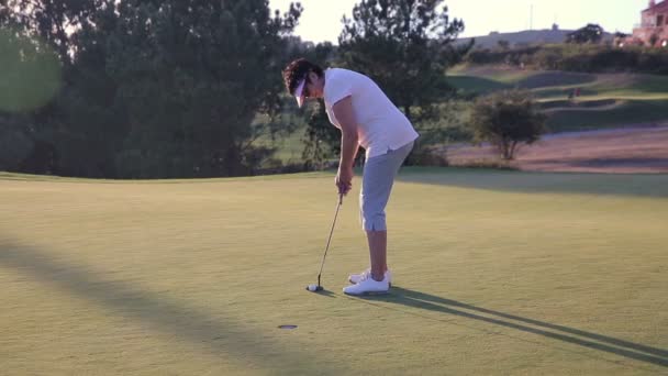 Aantrekkelijke rijpe vrouw speelt Golf bij Countryclub. — Stockvideo