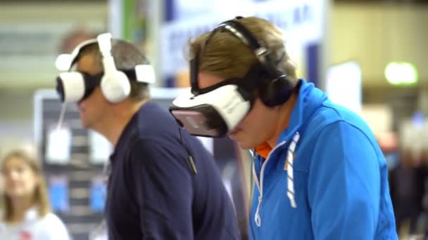 Virtual reality game. Two men uses a head mounted display. — Stock Video
