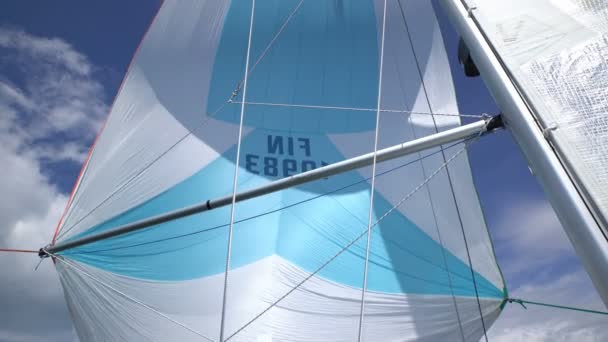 Spinnaker at the bow of yacht with blue skies and sunshine. — Stock Video