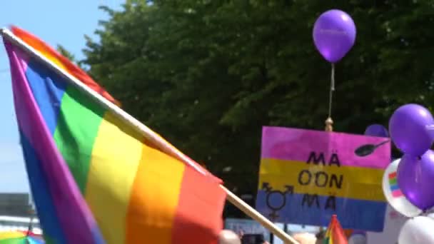 Rainbow flag during a Gay pride parade on the streets of Helsinki. — Stock Video