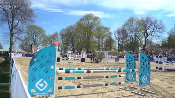 Horse riders jumping over a hurdle — Stock Video