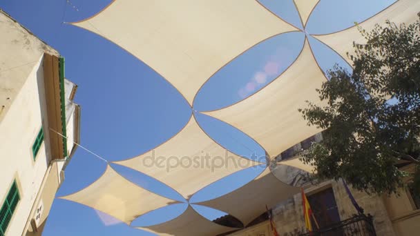 Parasols hanging over the street of a Small southern European town. — Stock Video