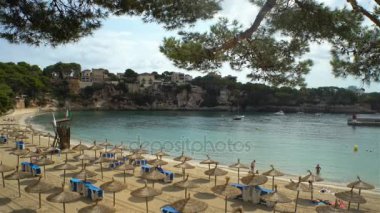 Hasır şemsiyeleri sahilde Porto Cristo Mallorca, İspanya