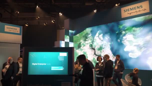 The Siemens stand with a huge advertising screen on a business forum — Stock Video