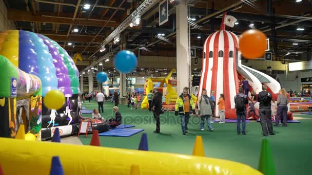 Finlandia s największy kryty park rozrywki. Wiele dzieci z rodzicami, grając na duży miękki plac zabaw — Wideo stockowe