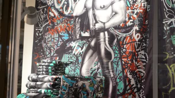 Collection of bed linen with homoerotic prints by Tom Of Finland in a shop window. — Stock Video