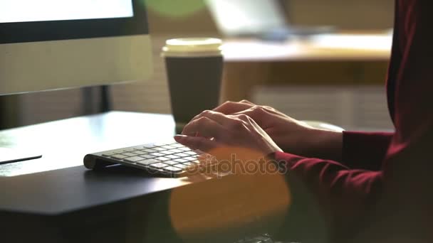 Una joven que trabaja en un escritorio con un teclado de computadora. Movimiento lento . — Vídeos de Stock