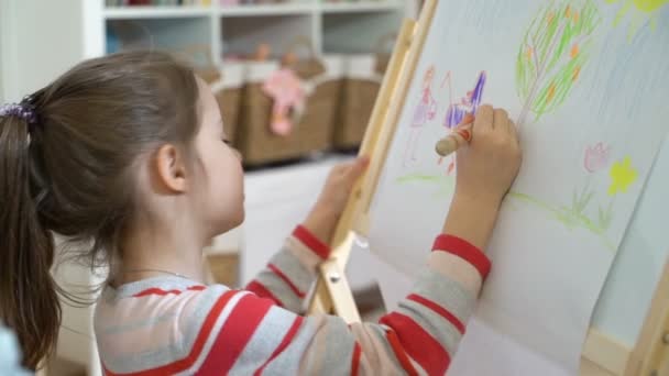 Pequena filha e sua mãe estão desenhando com lápis coloridos . — Vídeo de Stock