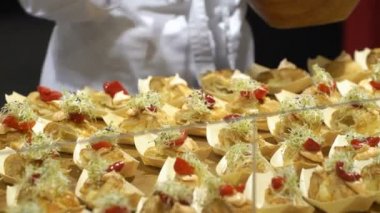 Aşçılar yemek örnekleri ziyaretçiler için gıda göstermek sırasında hazırlamak