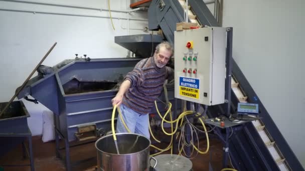 Produção de essências de perfume por destilação a vapor em cubo de destilação numa pequena aldeia alpina . — Vídeo de Stock