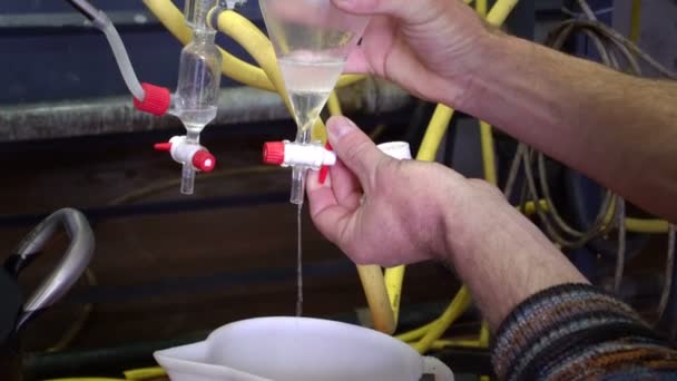 Производство парфюмерных эссенций с помощью паровой дистилляции в дистилляционном кубе в маленькой альпийской деревне . — стоковое видео