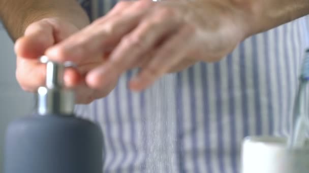 Middle-aged man washing hands in bathroom at home — Stock Video