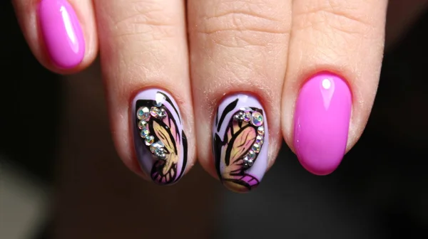 Pink nail gel polish with butterfly — Stock Photo, Image