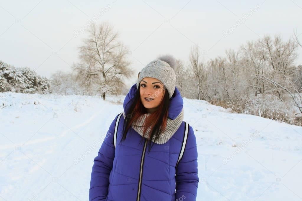 Beautiful girl in a snowy forest