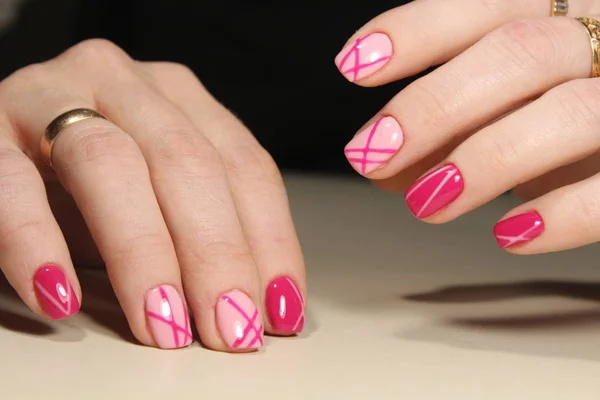 Manicured nails with pink nail polish.