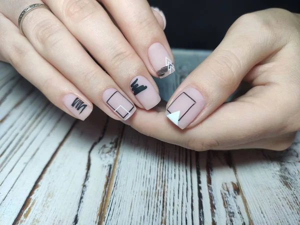 Closeup of hands of a young woman manicure on nails against white background — 스톡 사진