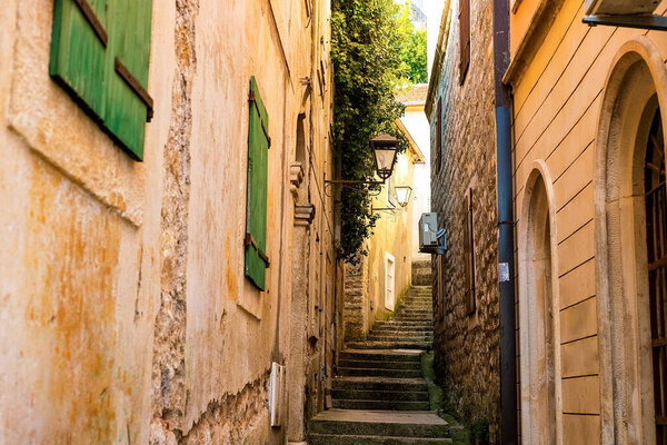 Winding street of the authentic, old town of Herceg Novi, Montenegro. We see old houses and very narrow.