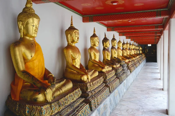 Fila de estatuas doradas de Buda en Wat Pho. Templo de la Reclinación —  Fotos de Stock