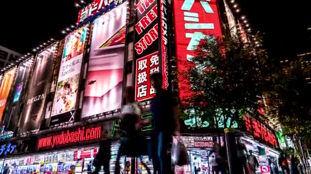 Tóquio - Vista noturna de rua com placas brilhantes e pessoas ambulantes, Shinjuku. 4K resolução tempo de inclinação lapso — Vídeo de Stock