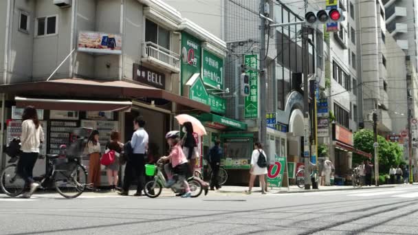 Tokyo - June 2016: Street view with traffic and people. Nakano. — Stock Video