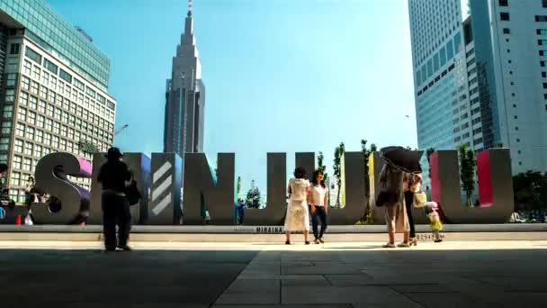 Tokyo - Time lapse of people in front of Shinjuku sign at JR Shinjuku Miraina Tower station. 4K resolution — Stock Video