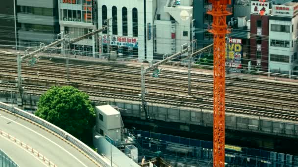 Tokyo - Flygfoto med tåg som passerar förbi. Det är Ginza. 4K-upplösningen ökar. Retro utseende. — Stockvideo