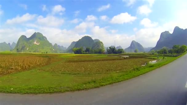 Slow motion ride through mountainous countryside with people planting rice. Vietnam — Stock Video
