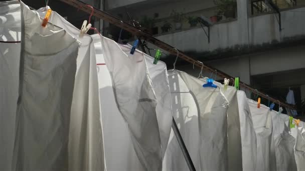 Hong Kong - Close up of hanging sheets with typical residential building in background. 4K resolution. Kowloon. October 2016 — Stock Video