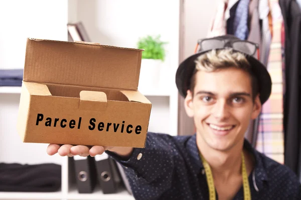 Young man working with the package to send by courier — Stock Photo, Image