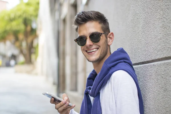 Young man with mobile phone — Stock Photo, Image