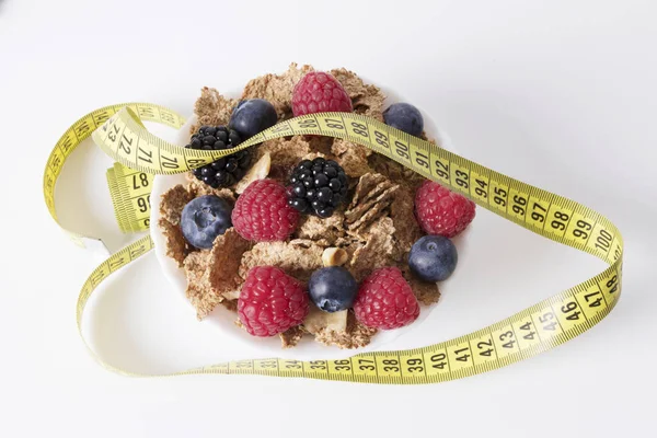 fruits with cereals and tape measure, diet concept