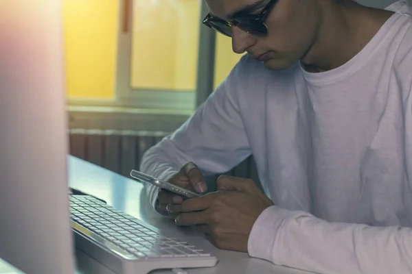 young with the phone and computer at home or in the office