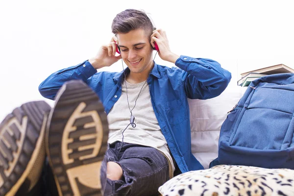 青少年躺在听音乐与手机和耳机 — 图库照片