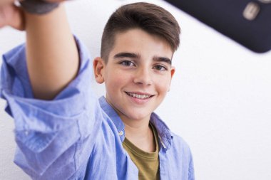 young teenager taking pictures with the phone clipart