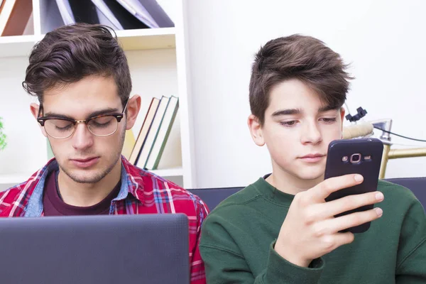 young people at home with the computer and mobile phone
