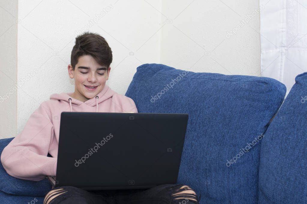 teenager with the laptop at home in the living room