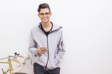 cep telefonu ve beyaz duvardaki vintage Bisiklet ile genç moda