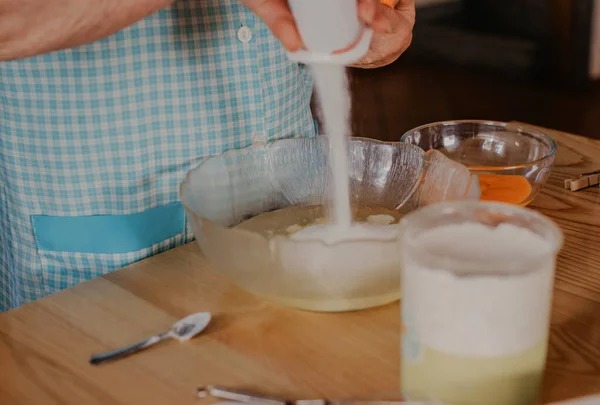 older woman preparing sweets and cakes at home