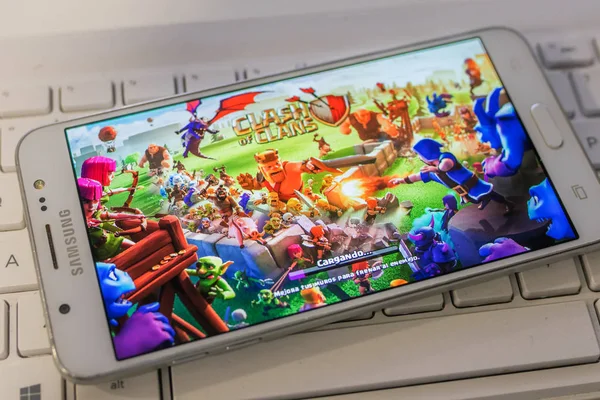 stock image Galicia, Spain - October 31, 2019: mobile phone with clash os clans game on its home screen loading