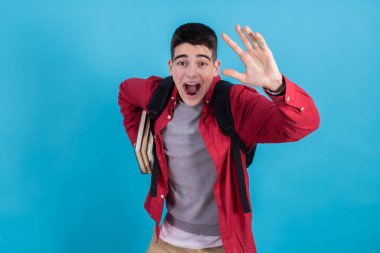 student running with books and backpack isolated on color background