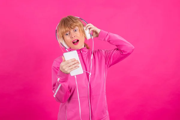 Adult Woman Mobile Phone Headphones Dancing Sportswear Pink Background — Stock Photo, Image