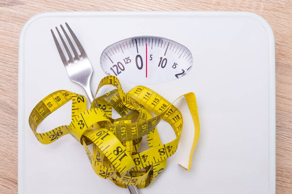 вилка с измерительной лентой и весовыми весами, концепцией питания и здоровья
